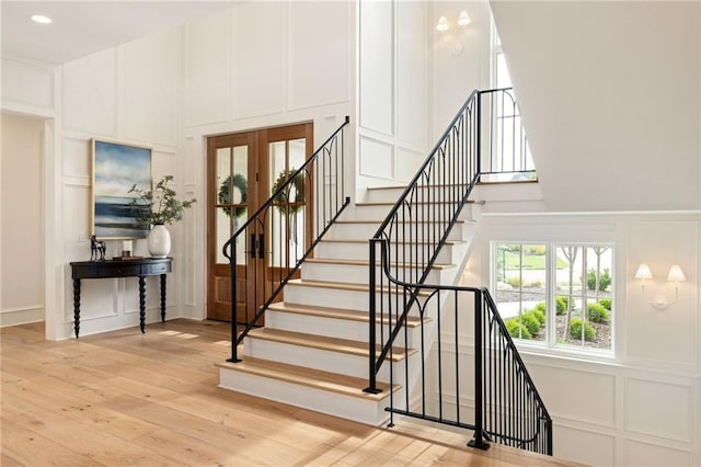 11316 W 170th Ter, Overland Park, KS 66221 - stairs with a decorative wall, wood-type flooring, a towering ceiling, and french doors