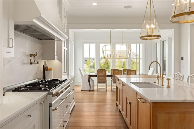 11316 W 170th Ter, Overland Park, KS 66221 - kitchen with a sink, premium range hood, a chandelier, gas stove, and light wood-type flooring