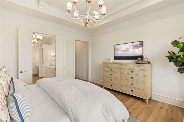 11316 W 170th Ter, Overland Park, KS 66221 - bedroom with a chandelier, light wood-style floors, baseboards, and ensuite bath