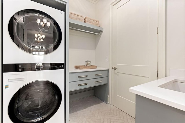 11316 W 170th Ter, Overland Park, KS 66221 - washroom featuring estacked washer and dryer and a chandelier