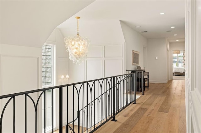 11316 W 170th Ter, Overland Park, KS 66221 - hall with an upstairs landing, a chandelier, light wood-style flooring, recessed lighting, and a decorative wall