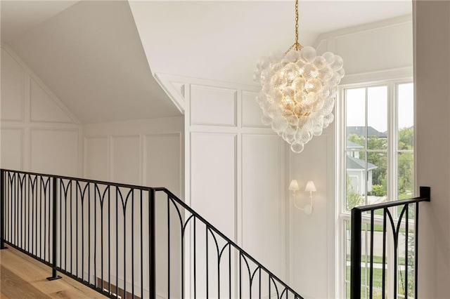 11316 W 170th Ter, Overland Park, KS 66221 - stairway featuring a decorative wall, a chandelier, lofted ceiling, and wood finished floors