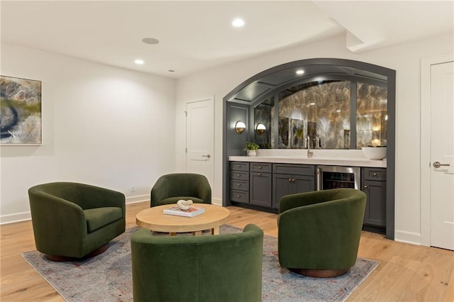11316 W 170th Ter, Overland Park, KS 66221 - living area featuring wine cooler, light wood-style floors, baseboards, recessed lighting, and bar