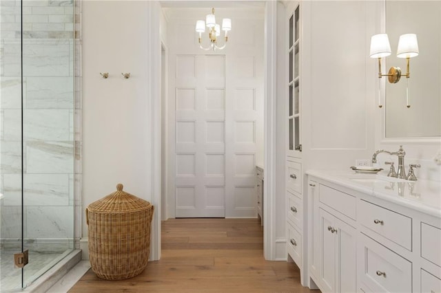 11316 W 170th Ter, Overland Park, KS 66221 - bathroom with vanity, wood finished floors, a marble finish shower, and a chandelier