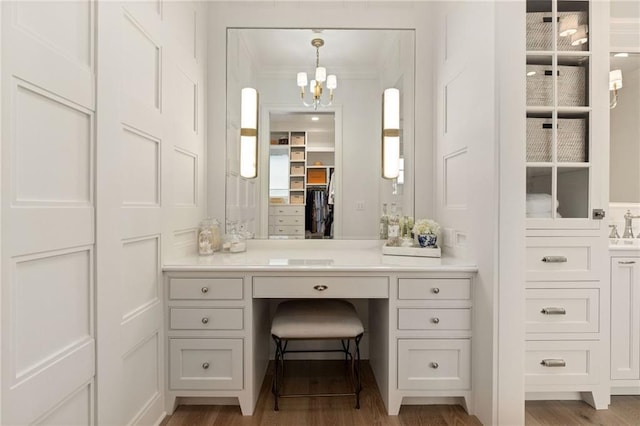 11316 W 170th Ter, Overland Park, KS 66221 - bathroom featuring a chandelier, wood finished floors, vanity, ornamental molding, and a walk in closet