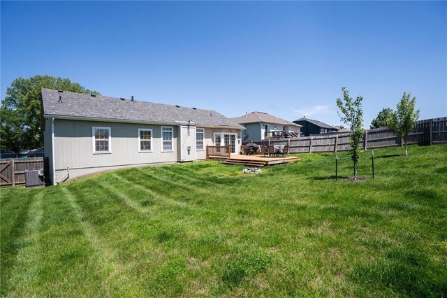 back of house with a wooden deck and central AC