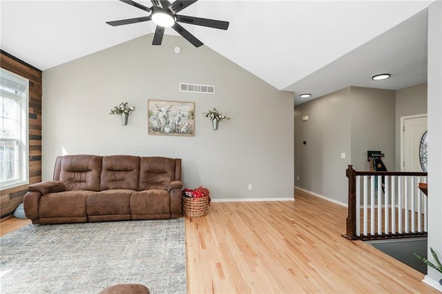 living area featuring wood finished floors, a ceiling fan, baseboards, lofted ceiling, and recessed lighting