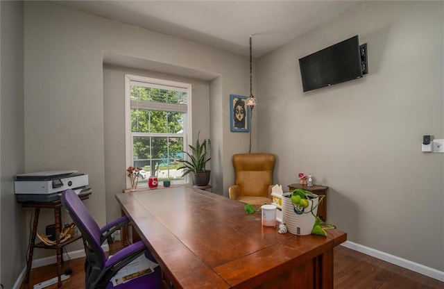 home office with baseboards and wood finished floors