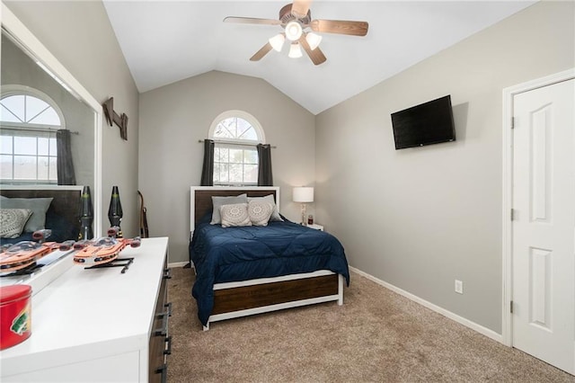 bedroom featuring carpet flooring, lofted ceiling, baseboards, and ceiling fan