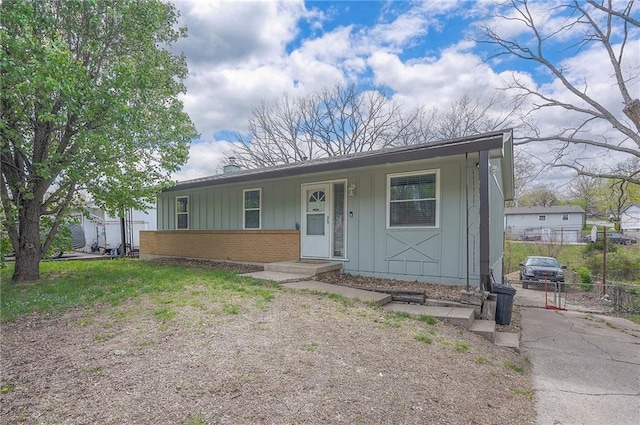 626 N 83rd Ter, Kansas City, KS 66112 - view of front of home featuring board and batten siding, brick siding, and fence