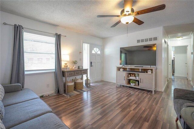 626 N 83rd Ter, Kansas City, KS 66112 - living area with a ceiling fan, wood finished floors, visible vents, and a textured ceiling
