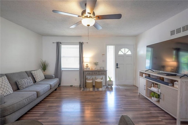 626 N 83rd Ter, Kansas City, KS 66112 - living area with a ceiling fan, wood finished floors, a textured ceiling, baseboards, and visible vents