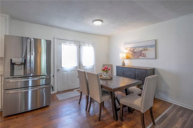 626 N 83rd Ter, Kansas City, KS 66112 - dining space with baseboards, dark wood-style flooring, and a textured ceiling