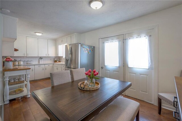 626 N 83rd Ter, Kansas City, KS 66112 - dining space with wood finished floors and a textured ceiling