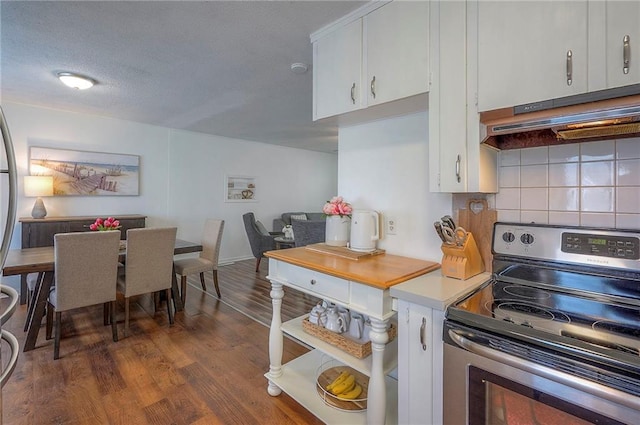 626 N 83rd Ter, Kansas City, KS 66112 - kitchen with dark wood-style floors, under cabinet range hood, stainless steel electric range, tasteful backsplash, and white cabinetry