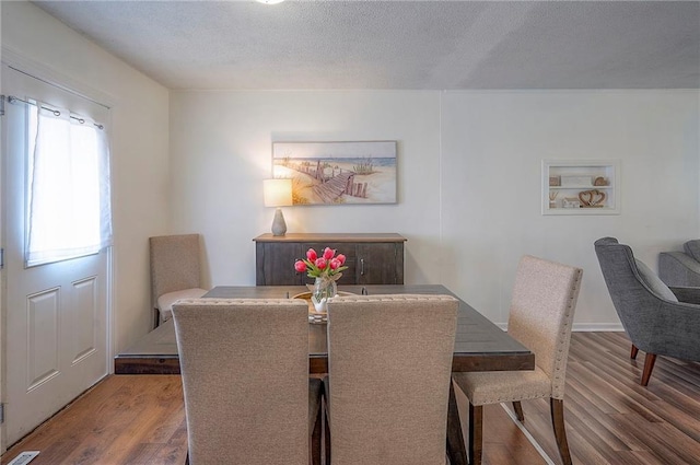 626 N 83rd Ter, Kansas City, KS 66112 - dining area with wood finished floors and a textured ceiling