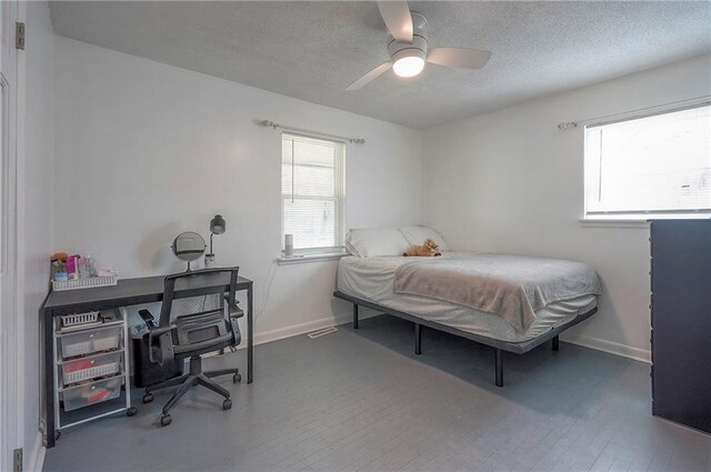 626 N 83rd Ter, Kansas City, KS 66112 - bedroom featuring baseboards, a ceiling fan, wood finished floors, and a textured ceiling