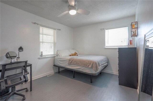 626 N 83rd Ter, Kansas City, KS 66112 - bedroom featuring wood finished floors, a textured ceiling, and baseboards