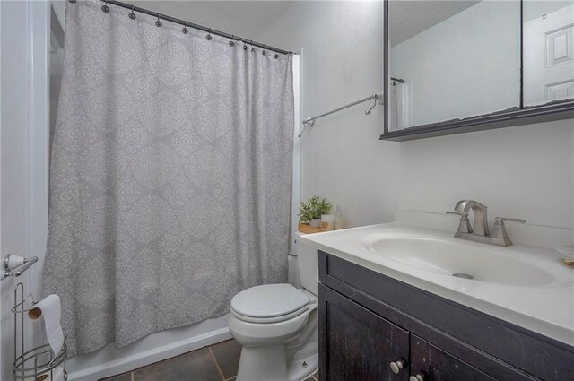 626 N 83rd Ter, Kansas City, KS 66112 - bathroom with tile patterned floors, a textured ceiling, vanity, toilet, and shower / bath combo with shower curtain