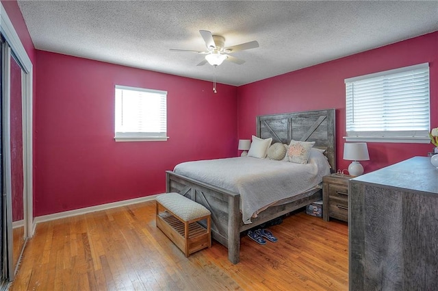 626 N 83rd Ter, Kansas City, KS 66112 - bedroom with a ceiling fan, baseboards, a textured ceiling, and wood-type flooring