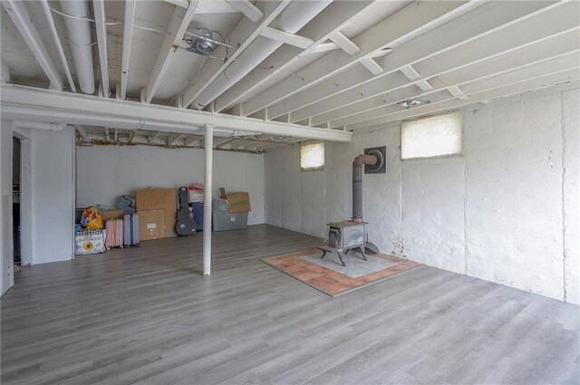 626 N 83rd Ter, Kansas City, KS 66112 - below grade area featuring wood finished floors and a wood stove