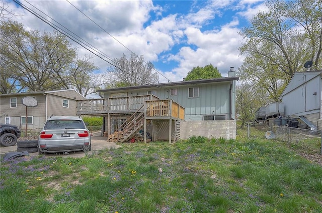 626 N 83rd Ter, Kansas City, KS 66112 - rear view of house featuring a chimney, a wooden deck, fence, and stairs