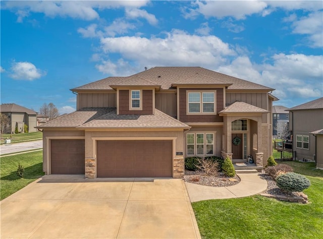 1237 Hillmann Ln, Warrensburg, MO 64093 - view of front facade featuring driveway, a shingled roof, a front lawn, stone siding, and an attached garage