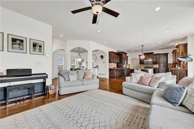1237 Hillmann Ln, Warrensburg, MO 64093 - living room featuring arched walkways, ceiling fan, dark wood-type flooring, and recessed lighting