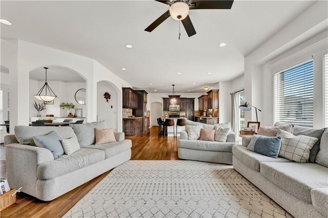 1237 Hillmann Ln, Warrensburg, MO 64093 - living room with wood finished floors, plenty of natural light, a ceiling fan, recessed lighting, and arched walkways