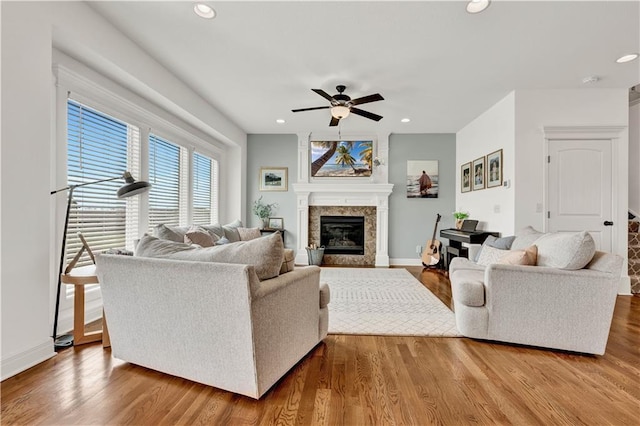 1237 Hillmann Ln, Warrensburg, MO 64093 - living area featuring a ceiling fan, a glass covered fireplace, wood finished floors, and recessed lighting