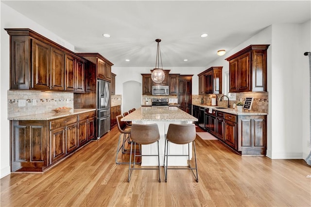 1237 Hillmann Ln, Warrensburg, MO 64093 - kitchen with stainless steel appliances, backsplash, a kitchen island, and recessed lighting