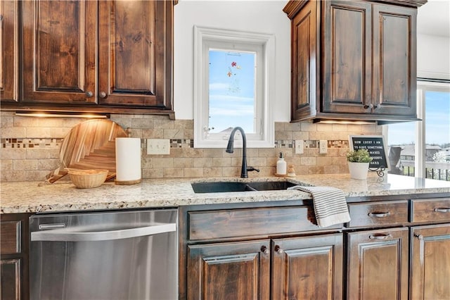 1237 Hillmann Ln, Warrensburg, MO 64093 - kitchen with stainless steel dishwasher, backsplash, light stone counters, and dark brown cabinets