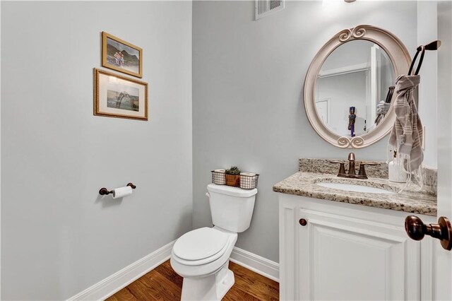 1237 Hillmann Ln, Warrensburg, MO 64093 - half bathroom featuring vanity and wood finished floors