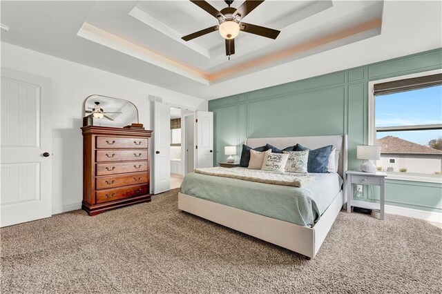 1237 Hillmann Ln, Warrensburg, MO 64093 - bedroom featuring a tray ceiling, carpet, ceiling fan, and ensuite bath