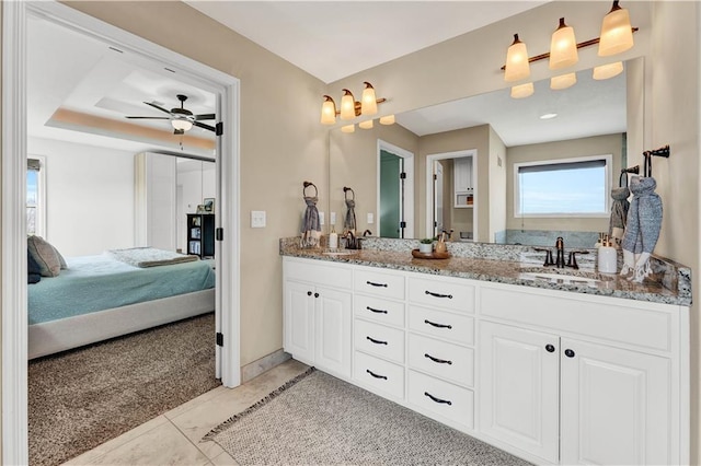 1237 Hillmann Ln, Warrensburg, MO 64093 - bathroom featuring connected bathroom, double vanity, ceiling fan, and tile patterned floors