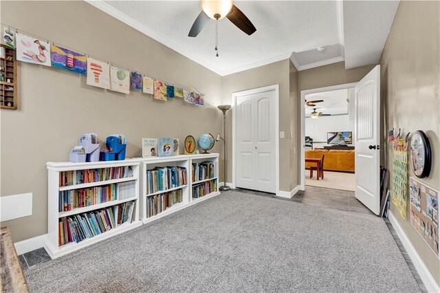 1237 Hillmann Ln, Warrensburg, MO 64093 - playroom with ceiling fan, ornamental molding, carpet floors, and a textured ceiling