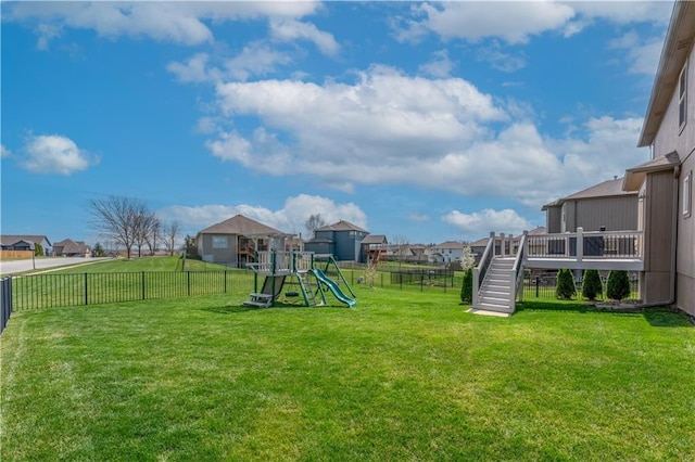 1237 Hillmann Ln, Warrensburg, MO 64093 - fenced backyard with a playground, stairway, a residential view, and a deck