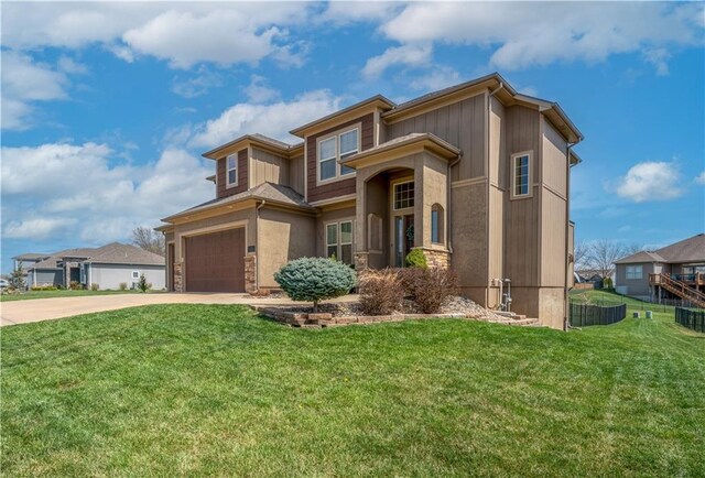 1237 Hillmann Ln, Warrensburg, MO 64093 - view of front of property featuring driveway, a garage, a front lawn, and stone siding