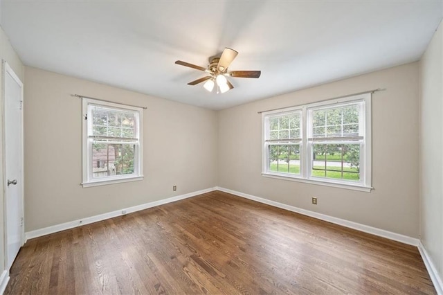 2015 Somerset Dr, Prairie Village, KS 66206 - unfurnished bedroom with baseboards, wood finished floors, and a ceiling fan