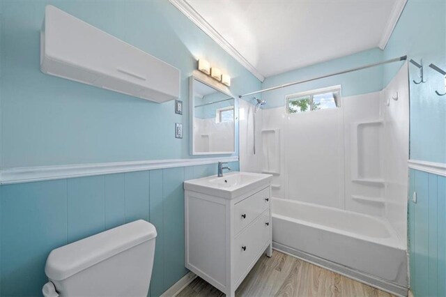 2015 Somerset Dr, Prairie Village, KS 66206 - full bath featuring toilet, vanity, wood finished floors, shower / bath combination, and wainscoting