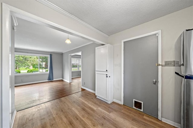 2015 Somerset Dr, Prairie Village, KS 66206 - unfurnished room featuring wood finished floors, baseboards, ornamental molding, and a textured ceiling