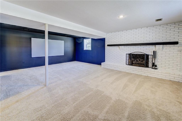 basement featuring a fireplace, carpet flooring, and visible vents