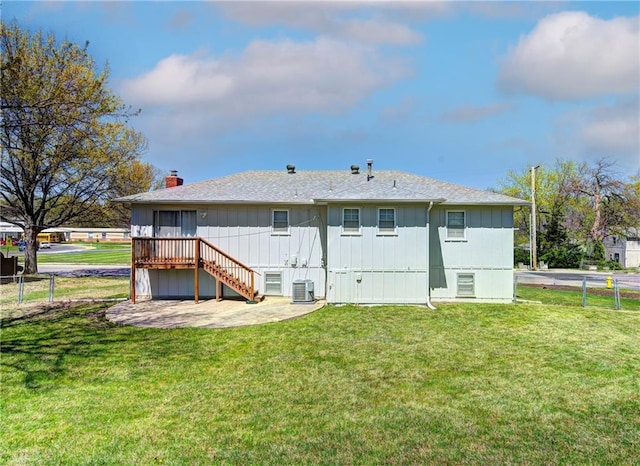 back of property featuring a yard, fence, stairway, and a patio area