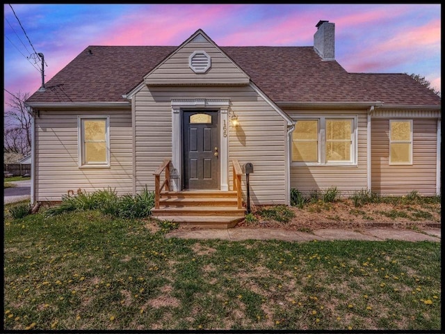 165 S Miami Ave, Marshall, MO 65340 - bungalow-style house with a yard, a shingled roof, and a chimney