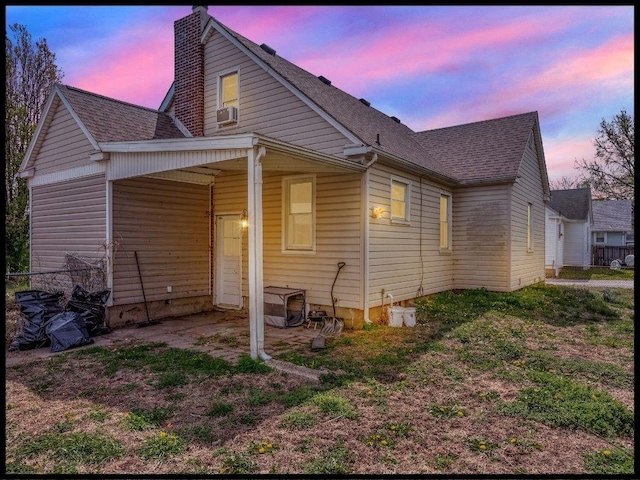 165 S Miami Ave, Marshall, MO 65340 - rear view of house featuring cooling unit, a shingled roof, and a chimney