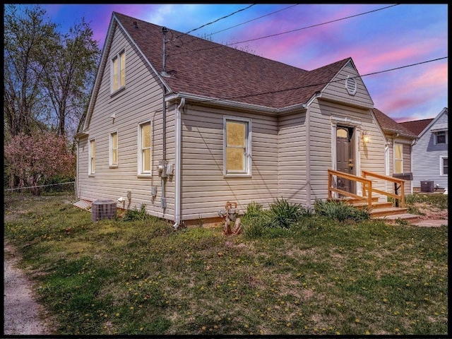 165 S Miami Ave, Marshall, MO 65340 - bungalow featuring central AC, fence, roof with shingles, and a lawn