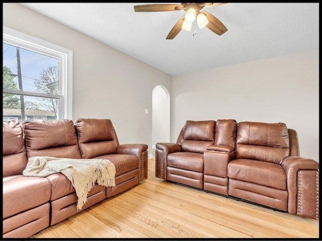165 S Miami Ave, Marshall, MO 65340 - living room featuring arched walkways, a ceiling fan, and light wood-style floors