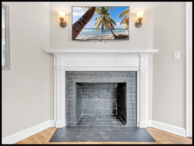 165 S Miami Ave, Marshall, MO 65340 - room details with a fireplace, wood finished floors, and baseboards
