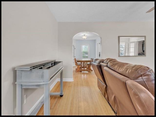 165 S Miami Ave, Marshall, MO 65340 - living area with arched walkways, baseboards, and light wood-style floors