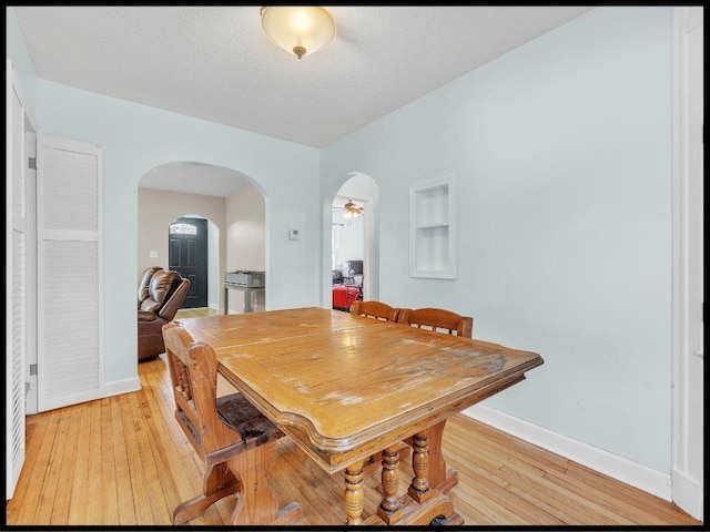 165 S Miami Ave, Marshall, MO 65340 - dining room with baseboards, light wood-style flooring, and arched walkways